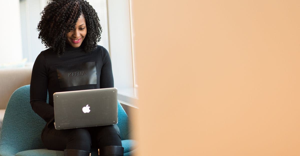 College graduate crafting their first professional resume on a laptop